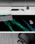 Striking 36x16 desk pad highlights glowing green lines against a dark backdrop with intricate circuit details in stunning contrast