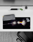 Moody black starlight mouse pad 28x12 inches with glowing rainbow bands and smoky prism light.