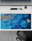Calming 32x16 mouse pad featuring oceanic blues and dynamic swirling patterns for a refreshing, visually engaging coastal design