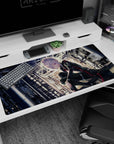 Silver-haired anime girl desk pad 40x20 inches, staring forward in black outfit with red trim and soft glow.