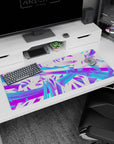 Artistic 36x16 inches desk pad featuring electric abstract design, with vibrant swirls of neon purple and electric blue plus sharp geometric shapes.