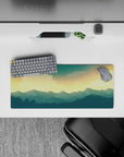 Tranquil 28x12 mouse pad featuring deep blue mountains and a golden sky for a serene and peaceful workspace atmosphere