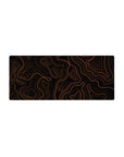 Mouse pad featuring an orange topographic design, 28x12 inches, with bold orange lines and a black backdrop for a modern, eye-catching aesthetic.