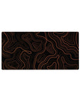 Mouse pad featuring an orange topographic design, 32x16 inches, with bold orange lines on a black backdrop, perfect for a modern and refined workspace.