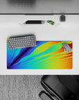 Radiant 28x12 mouse pad featuring an energetic burst of color with blues, greens, oranges, and yellows for a dynamic look