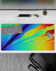 Energetic 32x16 mouse pad with vibrant blues, greens, oranges, and yellows, creating a digital sunrise for your desk