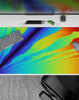 Energetic 40x20 desk pad with a radiant blend of blues, greens, oranges, and yellows, creating a digital sunrise effect