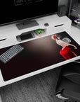 Long-haired anime girl in a shy pose desk pad 40x20 inches, red gown and ribbon amid smoky sparkles.