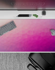 40x20 inches desk pad with a seamless blend of triangles in pink, purple, and peach, creating a subtle yet striking effect for a creative desk setup.