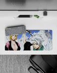 Anime mouse pad 28x12 inches featuring Bleach captains Rangiku and Tōshirō amid ice mountains, with stark whites and blues.