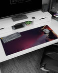 Artistic 36x16 inches desk pad showcasing Guts in his Berserker Armor, perched high against a dramatic sky, evoking isolation and relentless determination.