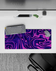 28x12 inches mouse pad with purple swirl abstract design, blending deep purples and vibrant pinks for a dynamic, motion-filled desk effect.