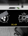 Anime desk pad 40x20 inches featuring Uchiha and Uzumaki clan seals from Naruto with ancient script on black background.