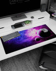 Space scene desk pad 36x16 inches showing two dark planets drifting through pink-purple nebula.