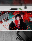 40x20 inches desk pad showcasing Itachi Uchiha beneath a canopy of red petals, embodying the complexity of his character.