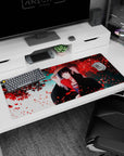 Artistic 36x16 inches desk pad with Itachi Uchiha, blending beauty and strength beneath a canopy of red petals.