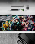 Demon Slayer anime desk pad 36x16 inches featuring Tanjiro, Nezuko, Zenitsu, Inosuke, and Giyu in an action-packed scene.