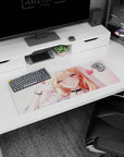 Flirty blonde anime girl with black choker and bracelets on a 32x12 inches mouse pad, hearts floating.