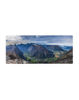 Mouse pad featuring mountain valley, 28x12 inches, with winding rivers, towering cliffs, and lush farmlands for a peaceful workspace effect.