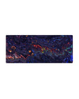 Mouse pad featuring a liquid abstract design, 28x12 inches, with deep blues, purples, and fiery reds, creating a dynamic and creative workspace.