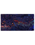 Mouse pad featuring a liquid abstract design, 32x16 inches, with deep blues, purples, and fiery reds creating a bold, dynamic atmosphere.