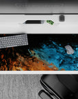 Cosmic 36x16 desk pad with fiery copper tones and deep blues, bringing the fluidity of the universe to your desk for a celestial touch