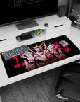36x16 inches desk pad featuring RX-0 Unicorn Gundam front-facing, jagged red lettering on black background.