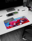 Sleepy brown-haired anime girl curled up on a mouse pad 28x12 inches in a red hoodie scene.