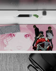 36x16 inches anime desk pad in noir smoky pink tones, clean linework, gritty gang mood.