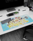 Nine anime idols mid-encore on a 36x16 inches desk pad, winks and peace signs with flower hair clips.