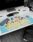 Nine anime idols mid-encore on a 40x20 inches desk pad, winks, peace signs, and flower clips.