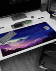 Serene 40x20 anime desk mat with starry night hues of purple and blue cascading over mountains for a tranquil cosmic workspace vibe