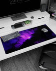 Deep space scene desk pad with violet nebula clouds and tiny star specks, 36x16 inches.