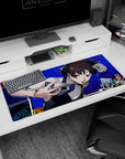 Makoto Niijima Persona 5 desk pad, 36x16 inches, with electric blue comic-style backdrop and floating tarot cards.