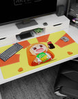 Chibi anime girl in hamster hoodie holding soda and chips on 40x20 inches desk pad, rosy cheeks grin.