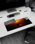 Solitude and mystery come to life in this 28x12 inches mouse pad, showcasing a lone figure under a fiery sunset with dark silhouettes, ideal for transforming your desk.