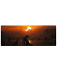 Compact 32x12 inches mouse pad featuring a lone figure kneeling under a fiery sunset with dark silhouettes, perfect for adding solitude and dramatic elegance to smaller desks.