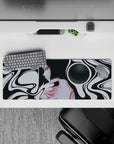 Elegant 32x12 mouse pad with black and white curves around a mysterious silhouette, accented with red and grayscale for a surreal touch