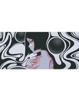 Surreal 36x16 desk pad featuring black and white flowing curves, a mysterious feminine silhouette, and soft red and grayscale details