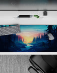 36x16 inches mouse pad with a forest sunrise, towering pines, and a serene river, creating a peaceful, outdoorsy atmosphere.