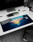 Artistic 36x16 inches mouse pad featuring a forest sunrise over pines and a river, perfect for a calming workspace.