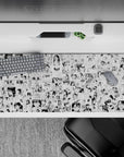 36x16 inches black-and-white anime desk pad with crisp ink linework and playful, blushy comic mood.