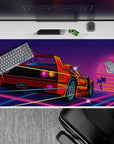 Futuristic 40x20 desk pad showcases retro sunset racer with glowing neon aesthetics for fans of fast cars