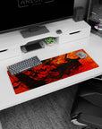 Artistic 32x12 inches mouse pad featuring fiery red and orange swirls with Guts in the Berserker Armor, perfect for bringing passion and power to your workspace.