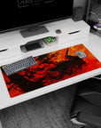 Artistic 36x16 inches desk pad featuring Guts in the heart of fiery chaos, with swirling red and orange tones, perfect for transforming your desk with fierce energy.