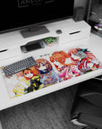 36x16 inches anime girl desk pad showing pink-haired blossom girl beside bunny-ear orange bob under sakura.