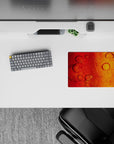 Small-sized 14x10 desk mat with abstract design adds bold, warm energy to any desk or workspace