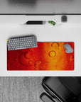Compact 28x12 desk mat highlights amber hues and flowing patterns for immersive warmth and creative vibes