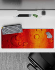 Intense 32x12 desk mat features flowing bubbles and warm tones with intricate amber details for fans of creativity