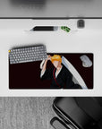Ichigo Kurosaki silhouette on 28x12 inch anime mouse pad from Bleach with black robes, orange hair, burgundy background.